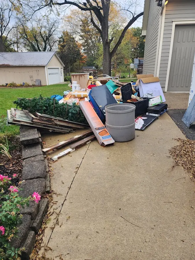 Dumpster being loaded with debris for Estate Cleanout Dumpster Rental in South Brooksville